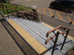 大宮町駐車場への階段の写真。手すりがついた広い階段です。近くにスロープの通路もあります。