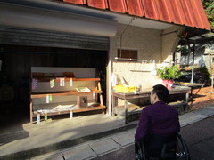 露天で野菜販売の写真。芋茎（ずいき）やシソ、里芋、白菜など地元の野菜を販売しています