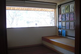 東氏記念館内の窓の写真。ベンチに座り、ゆったりと庭園の風景が望めるようになっています