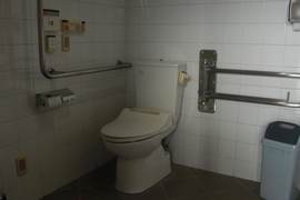 車いすマークトイレの写真。長い通路を通って館内に入る前のバスロータリーにあります